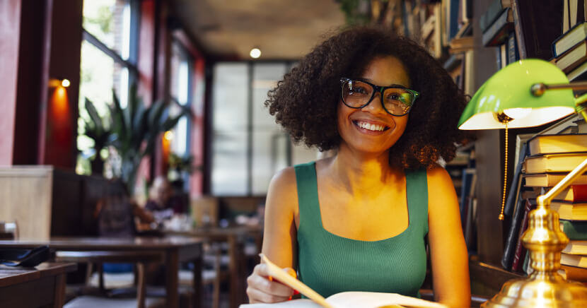 Happy-Woman-in-Cozy-Library