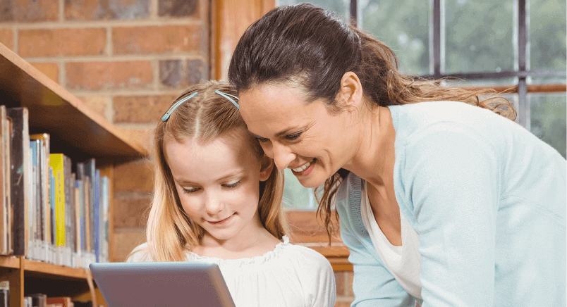 Librarian-Helping-Young-Child-On-Tablet