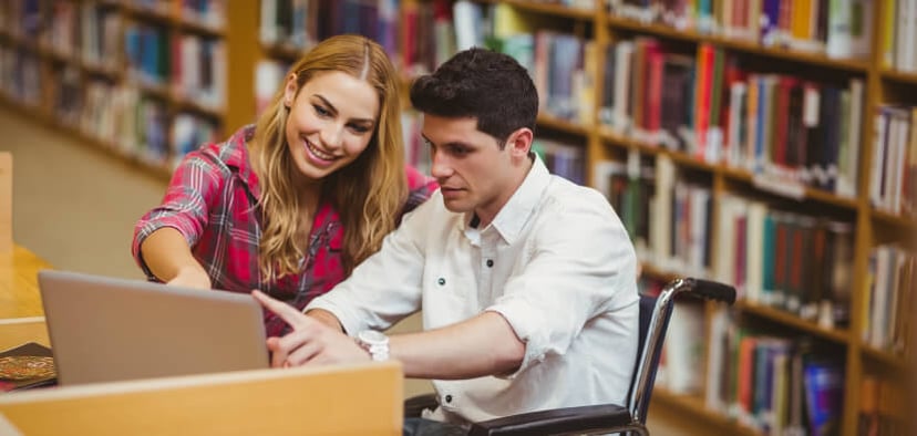 Two-young-people-working-on-laptop-in-library-jpg