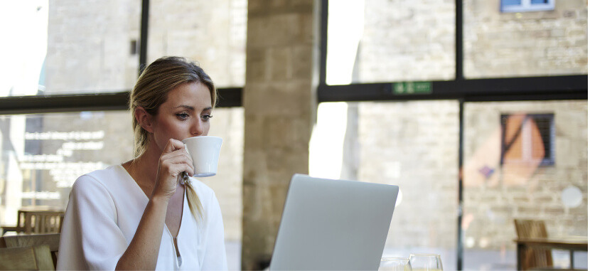 Woman-Drinking-Coffee-In-Library