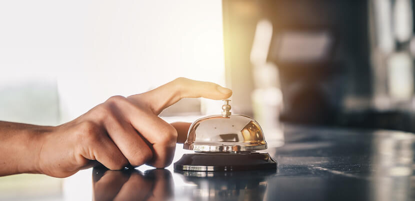 closeup-hand-ringing-bell-at-front-desk 