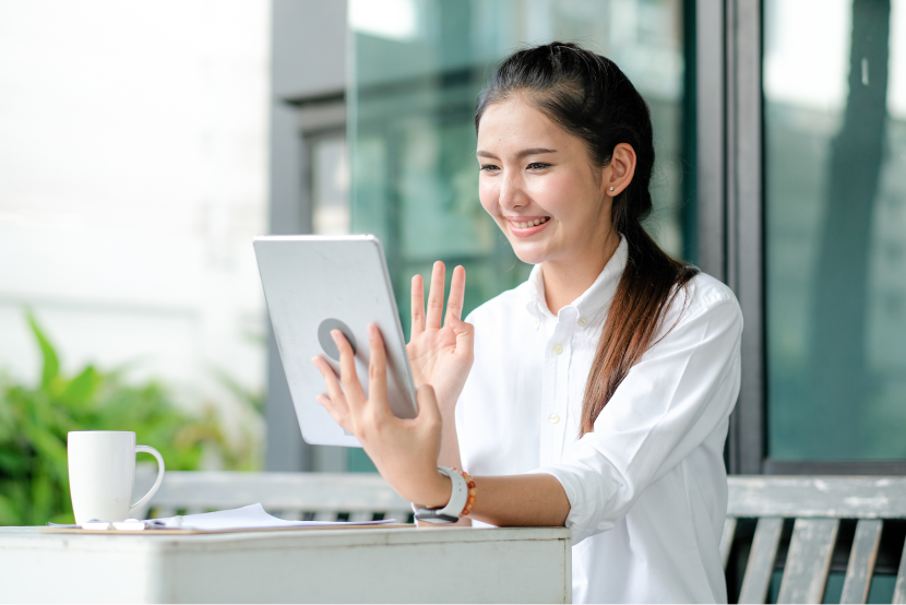 girl smiling greeting to-tablet