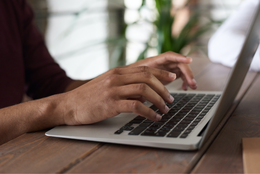 hand typing on a laptop