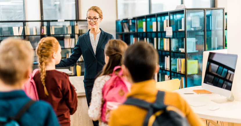 librarian-leading-a-group-of-young-students