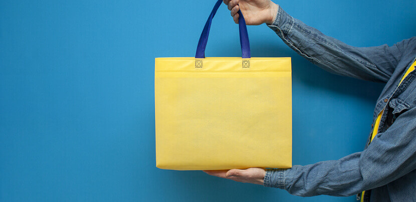 man-holding-a-reusable-tote-bag