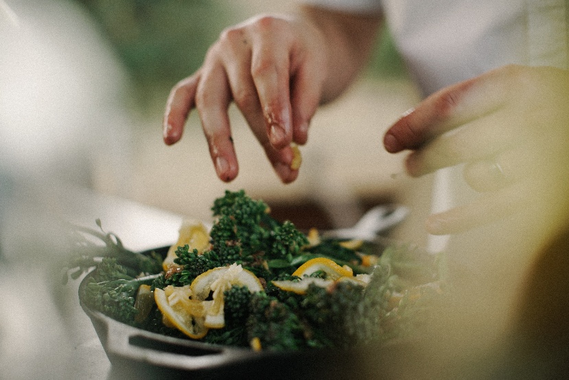 Hands mixing salad