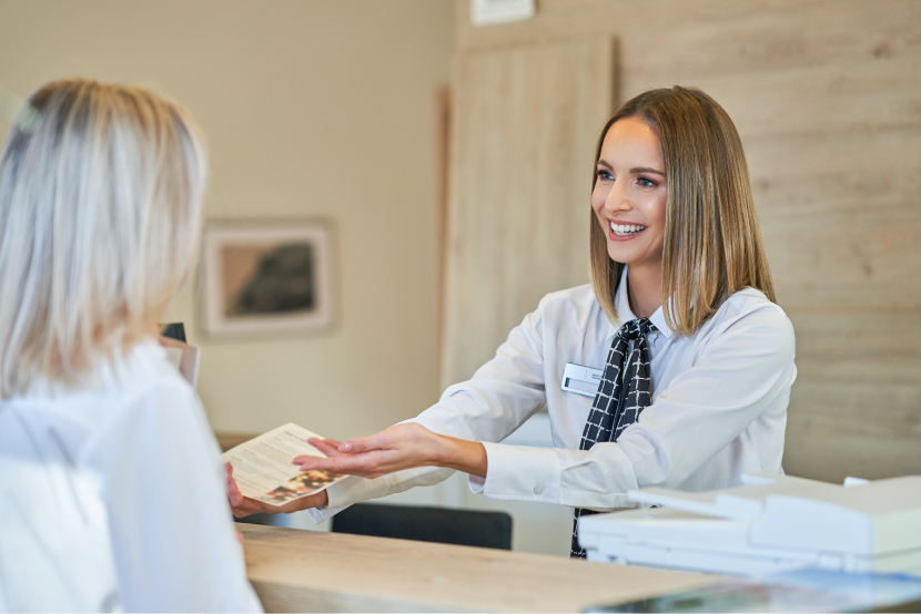 receptionist and businesswoman at hotel front desk