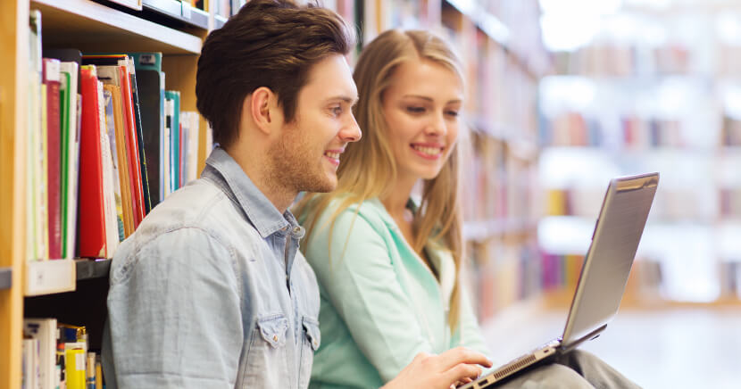 two-people-using-laptop-in-library