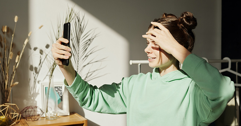 woman holding phone in front of her