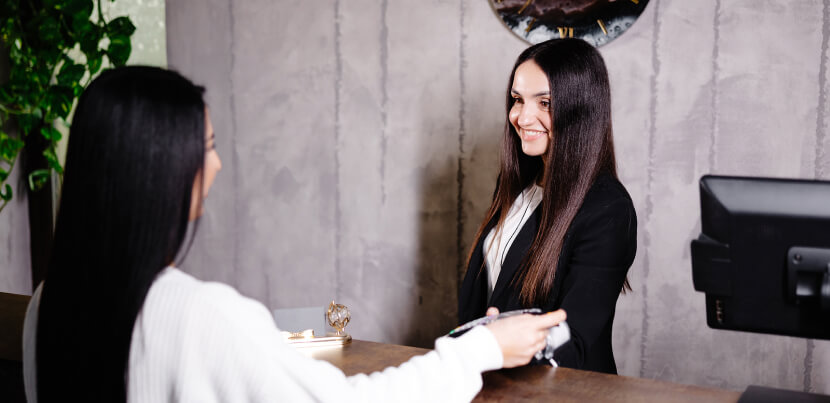 woman-checking-into-hotel