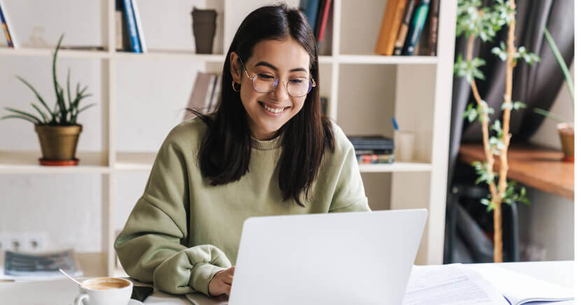 Happy-Young-Woman-Using-Laptop