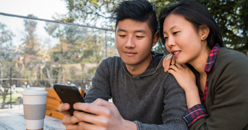 asian-couple-looking-at-smartphone