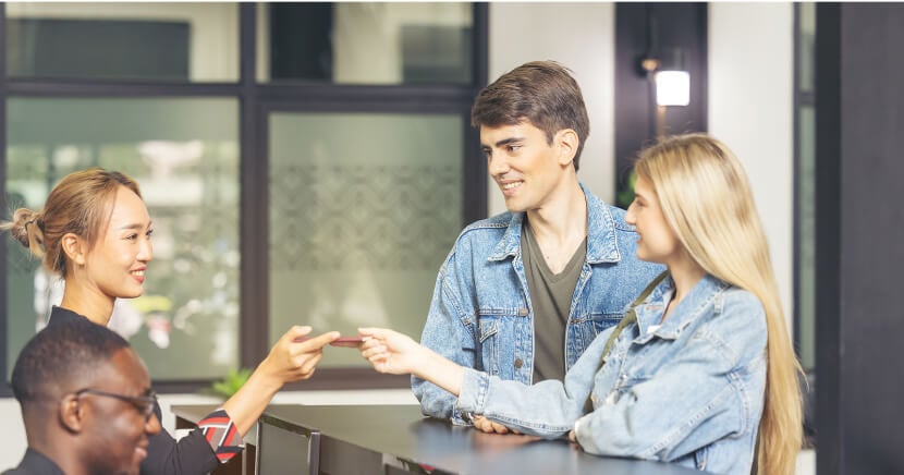 hotel-guests-checking-in-front-desk