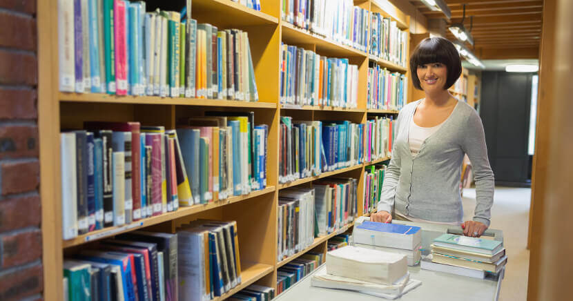 librarian-putting-books-on-shelf